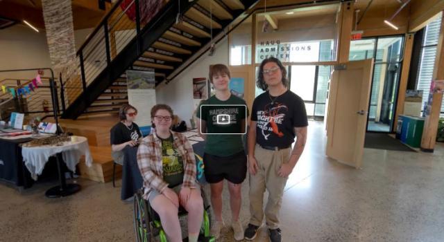 Still from virtual tour featuring three students in the center of the R.W. Kern Center lobby